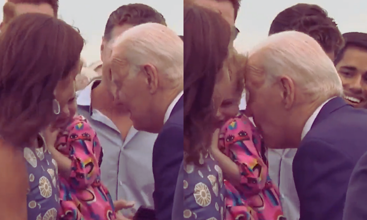 Photo: Joe Biden seen nibbling on a child's shoulder